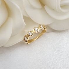 Stunning 14k gold Cubiz zirconia infinity band ring. A modern unique style that will add the final touch to all your outfits. Perfect everyday band. Comfortable & sturdy. 14k gold will not tarnish or rust. Shiny, elegant and everlasting. Will make the perfect gift for her. Materials: 14k gold Weight: 2.2 grams Band widht (top): 4.3mm Band widht (bottom): 2mm Stone count: 6  Total weight: 0.18 Ct 14k stamped  Brand new Fast shipping Contact me if you need a special size! 💓 Briza Collections is a Elegant Infinity Stackable Rings, Elegant 14k Gold Diamond Infinity Ring, Elegant Infinity 14k Gold Diamond Ring, Modern Twist Infinity Stackable Rings For Anniversary, 14k Gold Infinity Diamond Promise Ring, Anniversary Infinity Stackable Rings, Elegant Gold Infinity Stackable Rings, Gold Infinity Ring With Prong Setting, Gold Infinity Rings With Brilliant Cut