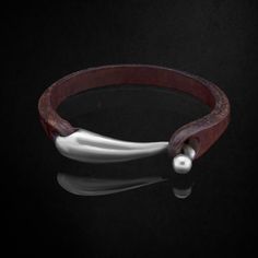 ➥ 925k Oxidized Sterling Silver and Leather Bracelet ➥ %100 Handmade Jewelry ➥ Unique, Authentic, Modern Design by Hodja Jewellery ➥ Perfect Gift for Special Occasions ➥ Cool Minimalist Design Bracelet Inspiration: ➥ Inspired by the Seas (follow us on Instagram @hodjajewellery to learn about the individual story that inspired the making of the bracelet). Double Quality Check ✓: ➥ It takes around 5-7 business days for us to craft, mold and ready your bracelet. This is so as we want your bracelet Classic Bracelets With Palladium Hardware For Everyday, Formal Leather Bangle Jewelry, Sterling Silver Classic Leather Bracelet As Gift, Classic Sterling Silver Leather Bracelet Gift, Leather Jewelry With Polished Finish As A Gift, Leather Jewelry With Polished Finish For Gift, Classic Engraved Silver Leather Bracelet, Silver Bracelet For Men, Bracelet Inspiration