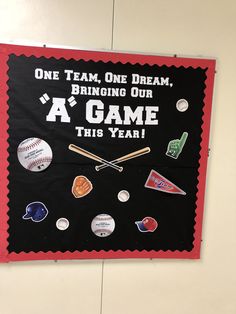 a baseball themed banner hanging on the wall in a school hallway that says one team, one dream, bringing our a'game this year