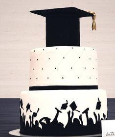 a graduation cake decorated with black and white frosting