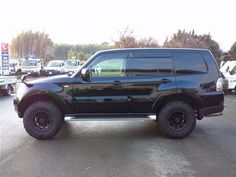 a large black suv parked in a parking lot