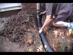 a man is working on a pipe in the ground