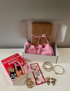 an open box containing jewelry and accessories on a table