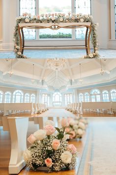 the ceremony room is decorated with white and pink flowers