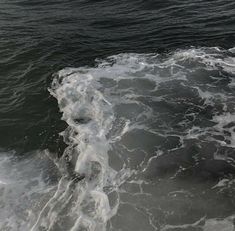 a person riding a surfboard on top of a wave in the ocean