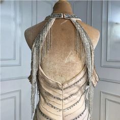 the back of a dress with fringes on it