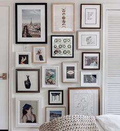 a bedroom with many pictures on the wall