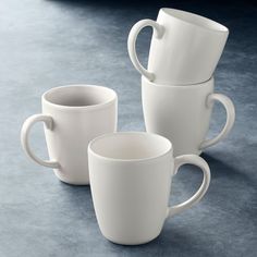 three white coffee mugs stacked on top of each other