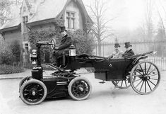 an old fashioned horse drawn carriage in front of a house with three men sitting on it