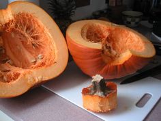 two pumpkins cut in half on a cutting board