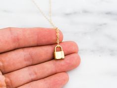 "Dainty lock necklace! The pendant is made of gold vermeil, which is heavy gold plating over sterling silver. Pair it with your favorite outfit! Layer with other necklaces, by or wear itself for a pop! . . . . . . . . . . . . . . . . . . . . . . . . . . . . . . . . . . . . . . . . . . NECKLACE + Length: 16\" + 2\" extender + Vermeil (18k gold plating over sterling silver) -or- sterling silver lock pendant: 8mm x 11mm + 14k gold filled -or- sterling silver chain, spring clasp, & findings LAYE Yellow Gold Chain Necklace With Gold Clasp As Gift, Gold Chain Necklace With Lock For Gift, Gold Lock Necklace As Gift, Everyday Gold Lock Jewelry, Everyday Gold Jewelry With Lock Detail, Yellow Gold Necklace With Lock As Gift, Lock Charm Necklace, Necklace Lock, Padlock Necklace