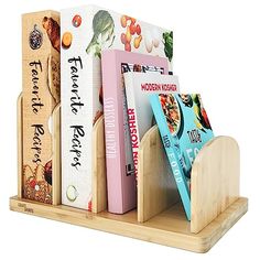 a wooden book holder with four books on it's sides and three different types of cookbooks in them