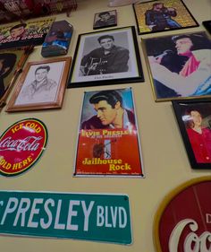 the wall is covered with posters and signs