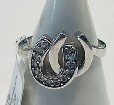 This beautiful sterling silver ring features a unique double horseshoe design, adorned with sparkling white topaz stones. The ring is a size 6 and crafted in a fine jewelry style, making it a perfect addition to any collection. The metal is high-quality silver, ensuring durability and longevity. The ring is ideal for those who appreciate fine jewelry and want to add a touch of elegance to their outfit. It would make a great gift for someone special or a treat for yourself. The white topaz stones add a touch of glamour to the piece, making it perfect for any occasion. Horseshoe Design, Horseshoe Jewelry, White Topaz Rings, Topaz Stone, Jewelry Style, Topaz Ring, White Topaz, Someone Special, Sterling Silver Ring