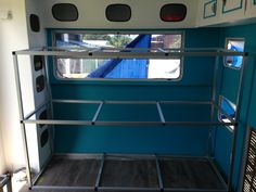 the inside of a blue and white trailer with stairs leading up to it's windows