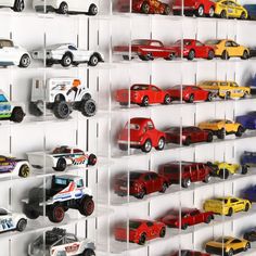 toy cars are lined up on shelves to display them