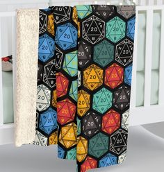 a baby crib with a blanket that has different colored dices and numbers on it