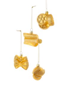 three gold earrings with shells hanging from them