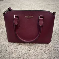 Even Though There Are No Tags, This Bag Is Practically Brand New. Very Few Uses In It. The Bag Is A Maroon Color With Gold Detailing. There Is Also A Long Strap That Can Be Added To Make It Into A Cross Body Bag If Wanted, Which Can Be Adjusted To Different Lengths. It Has A Small Inside Pocket, And A Top Zipper. I Am Willing To Negotiate On Prices. Kate Spade Handbag, Kate Spade Handbags, A Cross, Maroon Color, Kate Spade Bags, Kate Spade Bag, Cross Body Bag, Body Bag, Inside Pocket