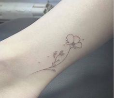 a small flower tattoo on the ankle