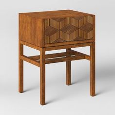 a wooden side table with an intricate design on the top and bottom shelf, made out of wood