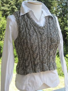 a woman's sweater vest is shown on a mannequin headdress