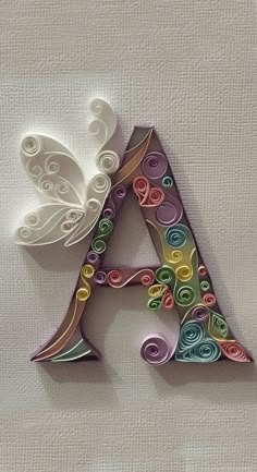 the letter a is made out of paper and decorated with swirls