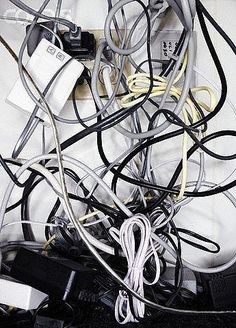 many wires and cords are tangled up in a pile on top of each other,