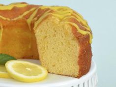 a bundt cake with lemon drizzled on top and slices cut out