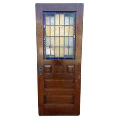 a wooden door with stained glass on it