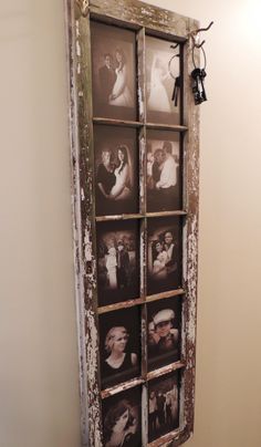 an old window with pictures hanging on it