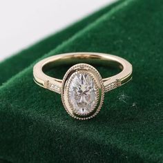 a close up of a ring on a green velvet