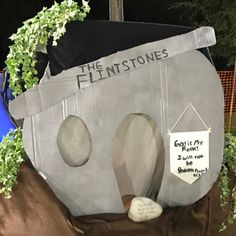 the flintstones'house is made out of cardboard and plastic, with plants growing in it