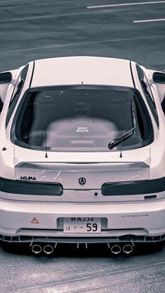 the rear end of a white sports car