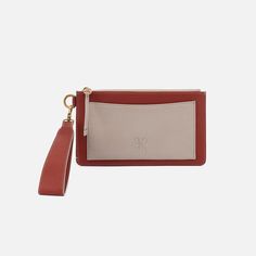 The Hart Wristlet has a removable strap so you can carry it as a clutch or oversized wallet. Hart Wristlet Wallet In Pebbled Leather  Rust Wristlet Wallet in Rust | Hobo® Leather Wristlet Pouch With Card Slots, Elegant Leather Wristlet With Card Slots, Leather Wristlet With Removable Pouch For On-the-go, Modern Wallets With Wrist Strap For Daily Use, Everyday Clutch Wallet With Wrist Strap, Large Wallet, Convertible Bags, Crossbody Wallet, Wristlet Wallet