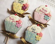 three decorated cupcakes on top of a table