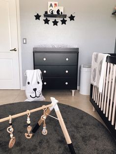 a baby's room with black and white decor