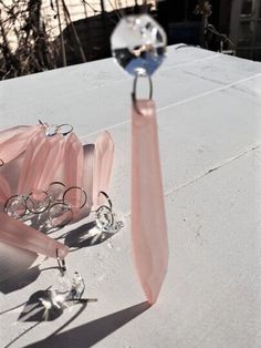 a pink tie and some glasses on top of a table