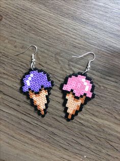 two pixelated ice cream cones are hanging from earrings