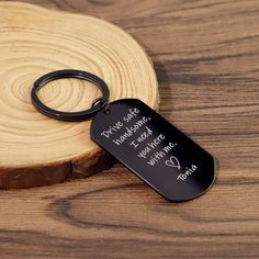 a black keychain with the words drive safe minnesota, michigan and indiana engraved on it