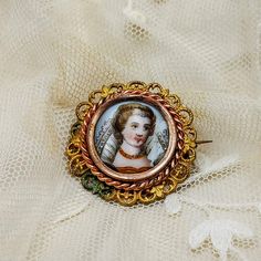 "Antique French brooch, gold color filigree, hand painted miniature on porcelain of a lady in Elizabethan costume, brooch with miniature. DESCRIPTION: Very lovley antique French brooch with a hand painted miniature on porcelain featuring a lady in Elizabethan costume, framed in gilt metal filigree, dating to early 1900's. HOW TO USE IT: A beautiful antique brooch with delightful miniature of lady, perfect gift for Valentine's Day! CONDITIONS: Good antique conditions, there are light oxydation tr Yellow Gold Enamel Brooches, Victorian Brooches For Ceremonial Occasions, Victorian Style Enamel Pin Gift, Victorian Style Wedding Brooch Enamel Pin, Victorian Wedding Enamel Brooch Pin, Victorian Style Wedding Enamel Brooch Pin, Victorian Gold Enamel Pin, Victorian Style Gold Enamel Pin, Wedding Enamel Pin Brooch