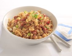 a white bowl filled with rice and vegetables