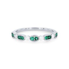 a white gold ring with emeralds and diamonds