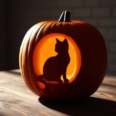 a carved pumpkin with a cat in the center and an orange light shining on it