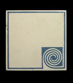 a white and blue tile with a spiral design on the bottom, against a black background