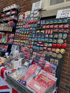 the british flag is on display in front of a store with souvenirs and magnets