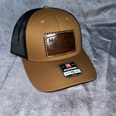 Do You Need Your Business Laser On Leather Patch, Sewn Onto Richardson Trucker Curve Or Flat Bill? This Is A Perfect Way To Sport Your Design! Casual Brown Leather Hat, Brown Casual Trucker Hat With Curved Brim, Casual Brown Trucker Hat With Curved Brim, Fitted Brown Casual Hat, Casual Fitted Brown Hat, Brown Leather Trucker Hat, Brown Hats With Leather Backing For Outdoor, Brown Leather Snapback Trucker Hat, Outdoor Brown Hats With Leather Backing