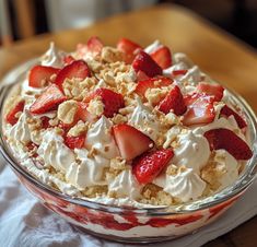 a bowl filled with whipped cream and strawberries