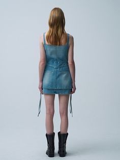 This product is a trendy double D-ring mini dress made from light denim, offering a stylish and youthful appearance. It features a front zip closure that enhances its edgy look and allows for easy wearability. The dress is accented with two large pockets and adjustable D-ring straps, adding both functionality and a modern touch to its overall design. - This dress is characterized by its unique double D-ring straps, providing adjustable fit and fashion-forward detailing.- Features a convenient front zip closure, making it easy to wear and adding an urban edge.- Includes two large front pockets, enhancing its practicality and style.- Crafted from light denim, this mini dress is both durable and comfortable for daily wear. Denim Blue Mini Dress, Casual Mini Dress With Back Zipper, Back Zipper Mini Denim Dress, Knee-length Mini Dress With Zipper Closure For Summer, Trendy Mini Dress With Back Zipper, Summer Knee-length Mini Dress With Zipper Closure, Knee-length Summer Mini Dress With Zipper, Summer Knee-length Mini Dress With Zipper, Chic Summer Denim Dress With Back Zipper