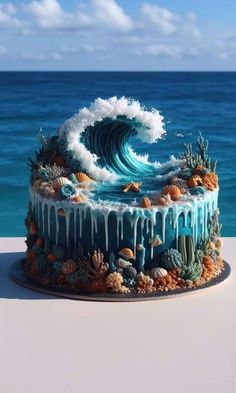 a cake with blue icing and an ocean wave on top